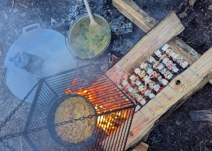 Team cooking over an open fire
