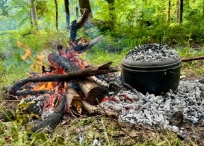 Team cooking over an open fire