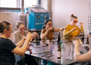 Turning glass beads in a team